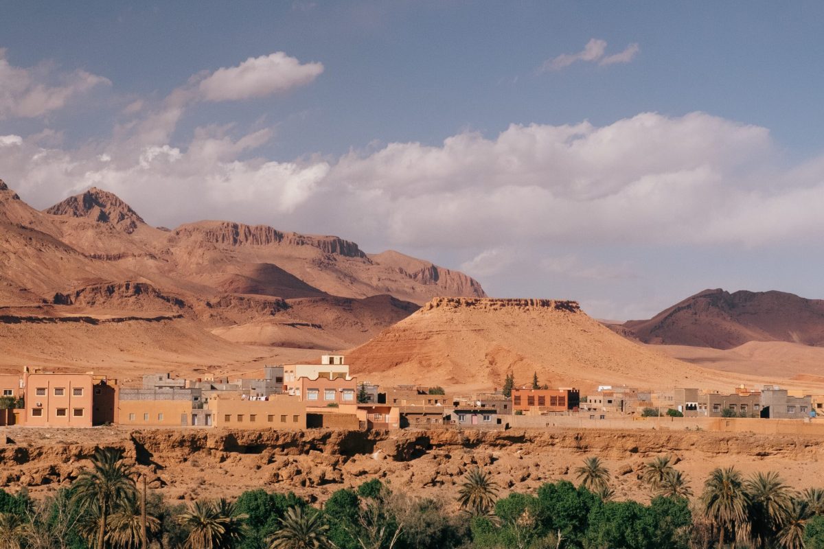 A wide angle shot of the buildings of a city behind the mountains